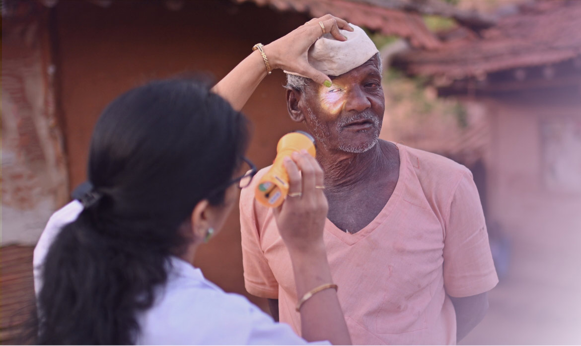 Doctor examining the eyes of an old man